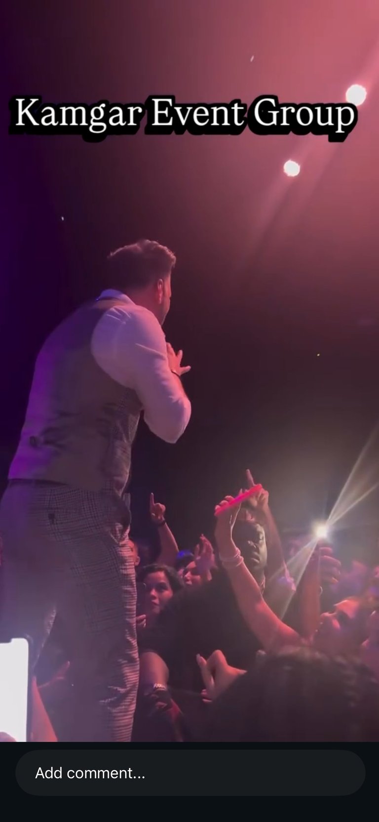 Performer on stage addressing crowd